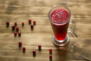 Cranberry drink on wooden table