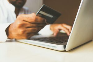 person using card to pay for something on laptop
